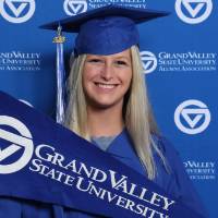 Future alumna holds GV flag at Gradfest